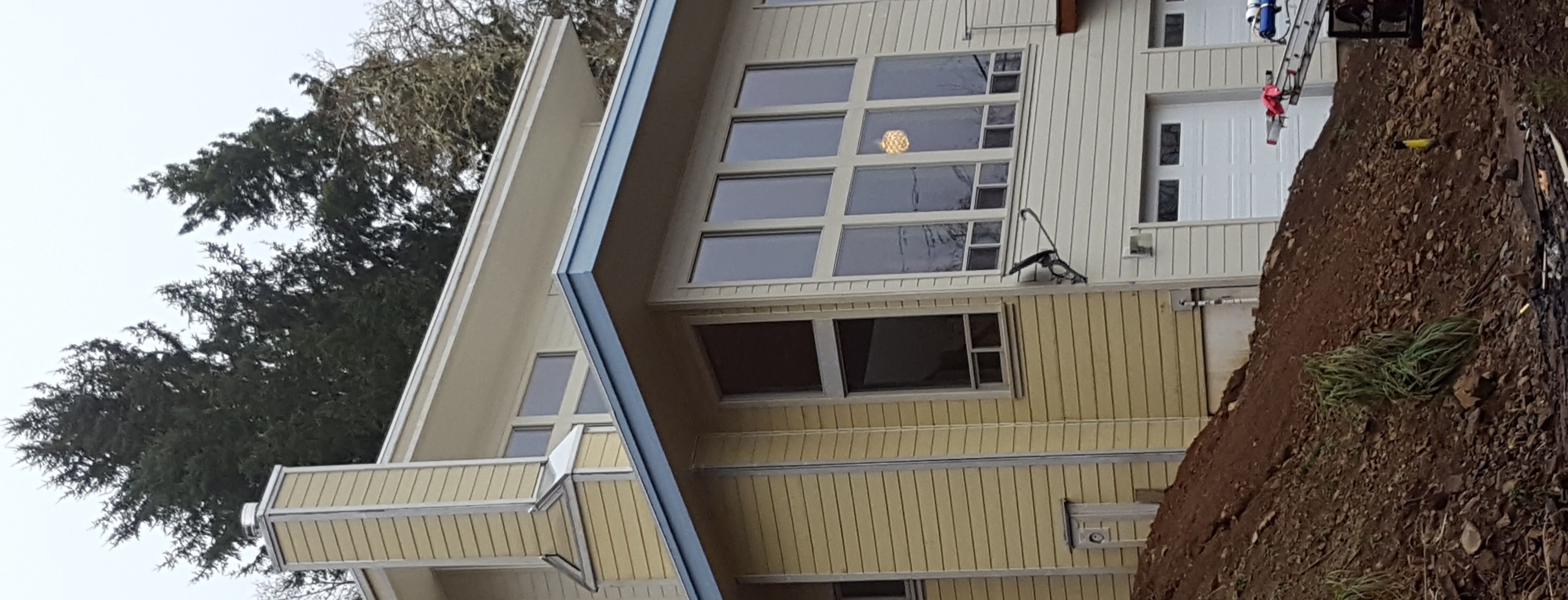 Large coastal home with two-story glass wall